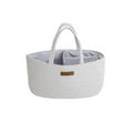 A light gray woven fabric storage basket with two top handles and a striped interior, shown on a plain white background.