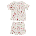 Kids short sleeve cotton pjs with an all over bows, flowers and hearts print on a white background. 