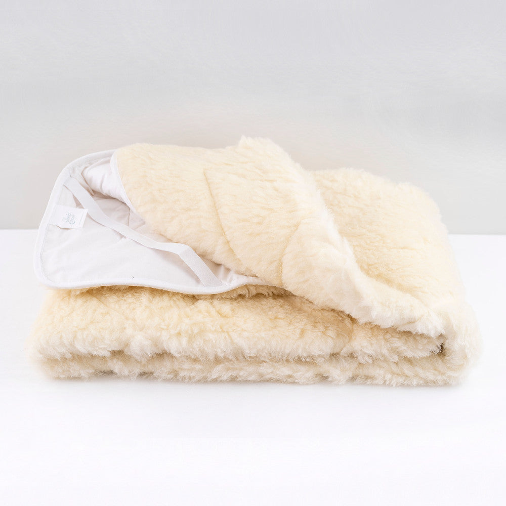reversible wool underlay with white elastic backing and white elastic straps