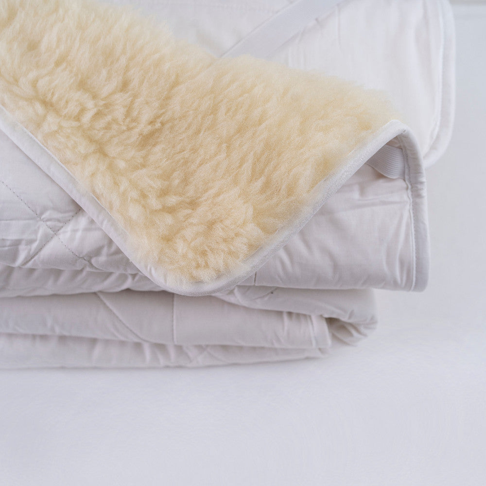quilted wool underlay with reversible cotton backing on white background