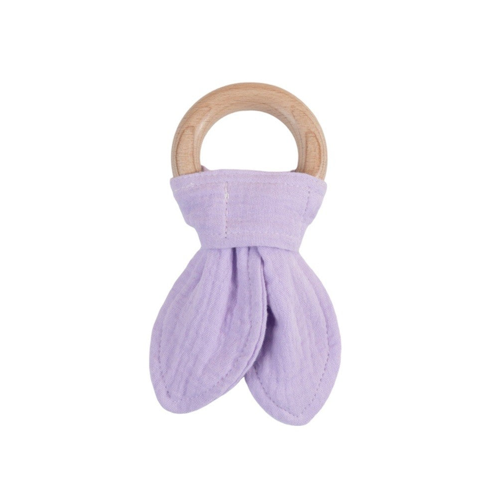 Purple muslin baby teether with wooden ring on a white background