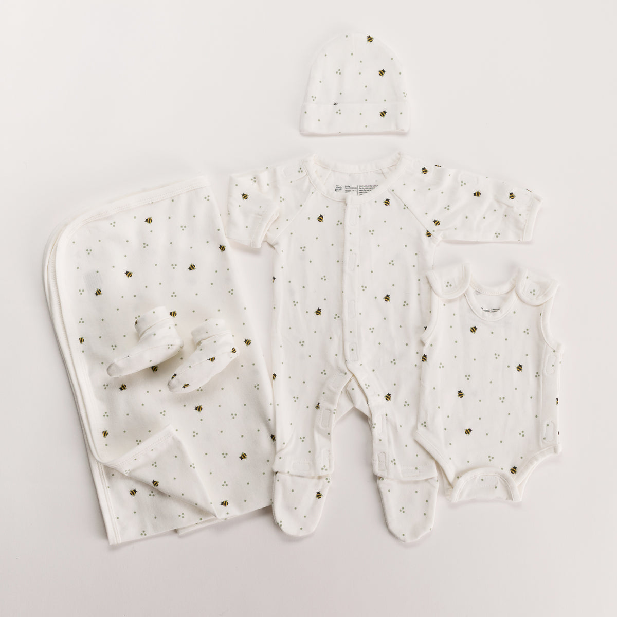 Bee Print gift pack with onesie, singletsuit booties, beanie and swaddle on white background