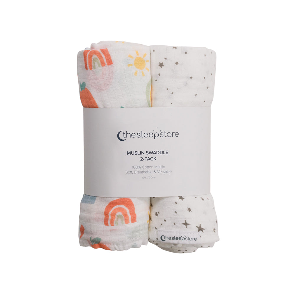 Two muslin swaddles in rainbow and star patterns with packaging from The Sleep Store on a white background.