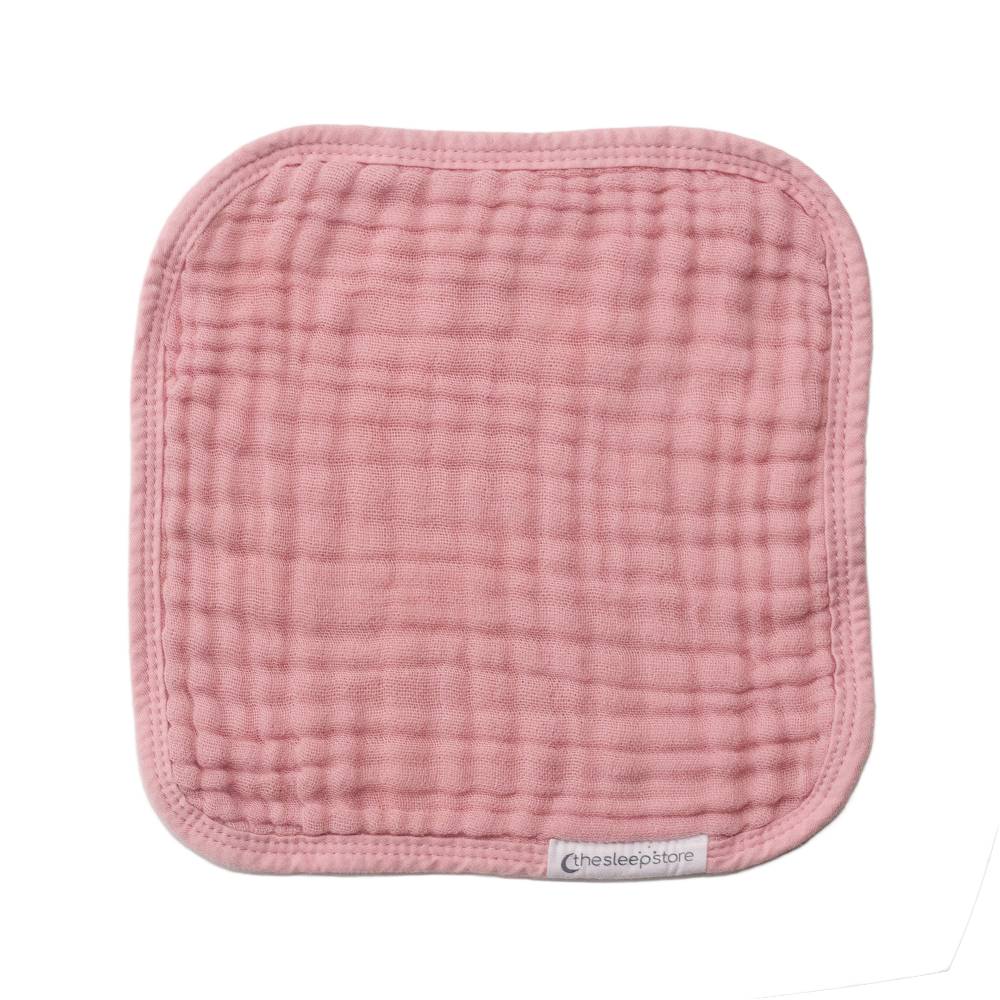 Pink muslin face cloth on a white background