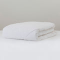 Wool duvet inner folded on a white background