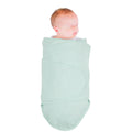 Baby wrapped in a mint coloured miracle blanket swaddle on a white background