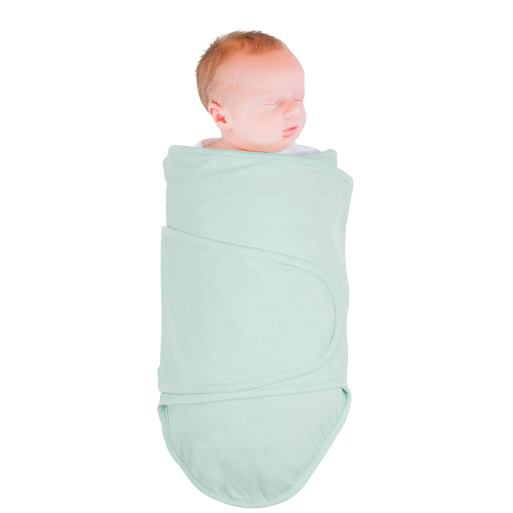 Baby wrapped in a mint coloured miracle blanket swaddle on a white background