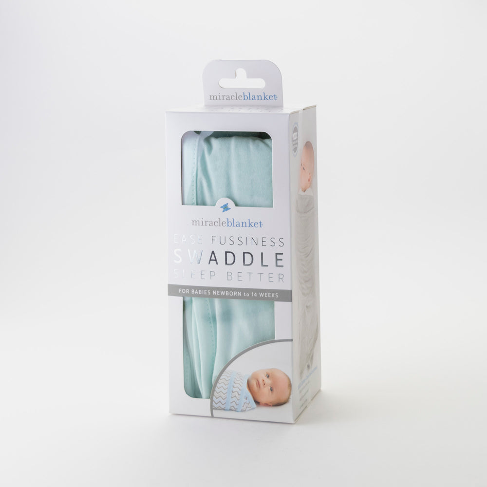 Package of a mint green swaddle blanket with a baby illustration on a white background