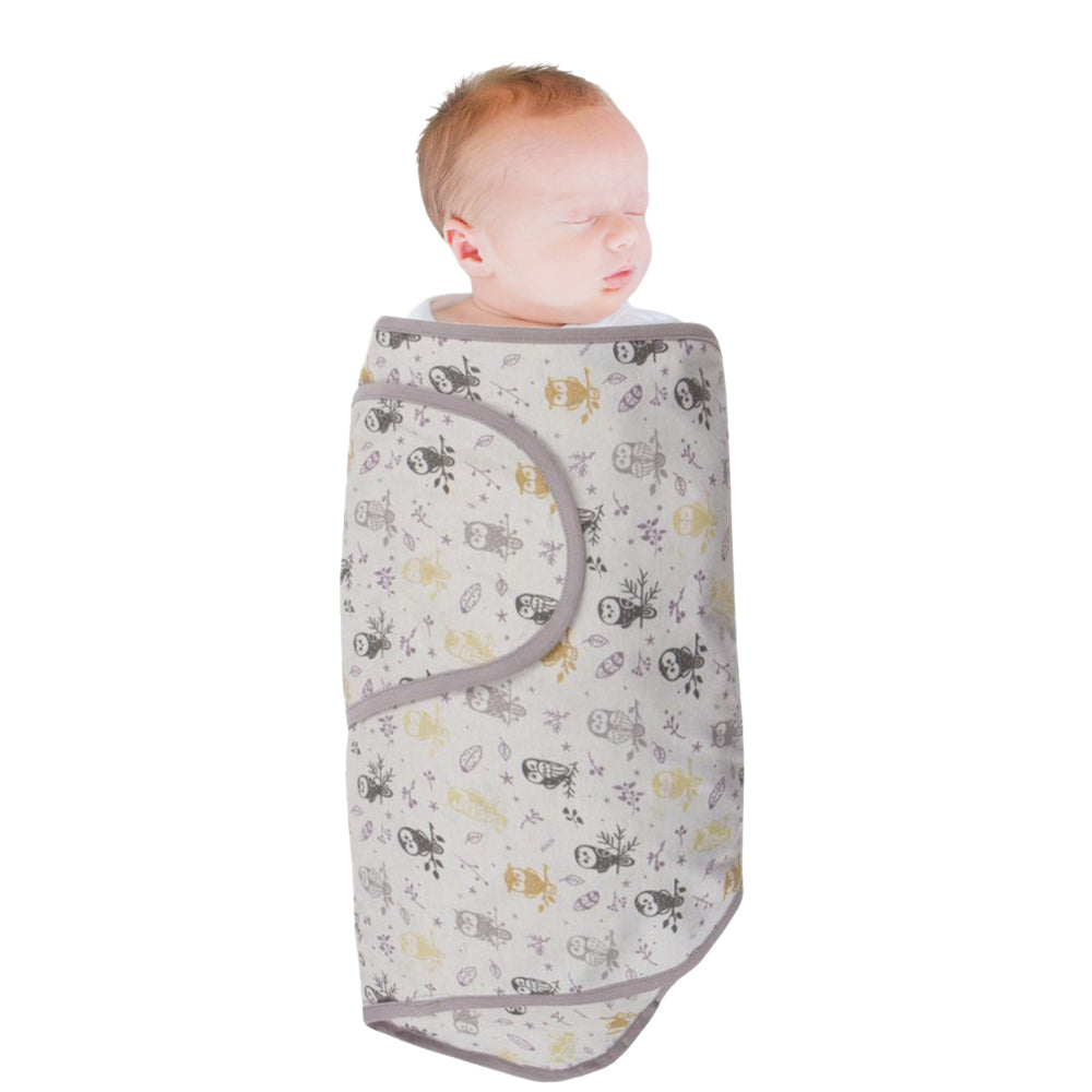 Baby wrapped in a grey owl patterned miracle blanket swaddle on a white background