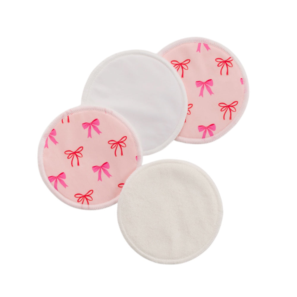 2 pairs of bamboo reusable breast pads with pink bow pattern on a white background