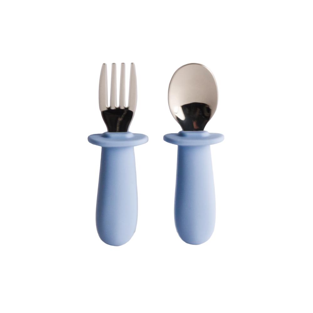Nestling baby cutlery set of fork and spoon with blue silicone handles on a white background