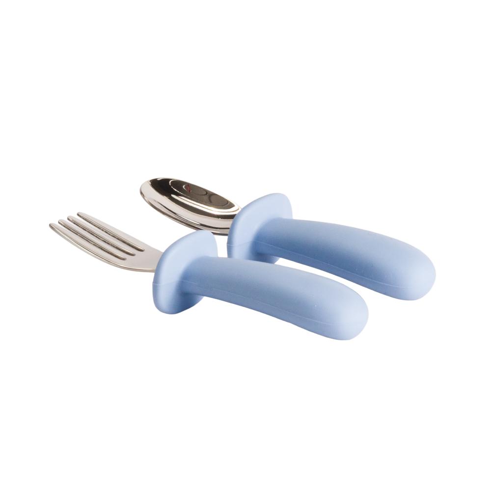 Nestling baby fork and spoon set with light blue handles on a white background