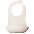 Beige silicone bib on a white background