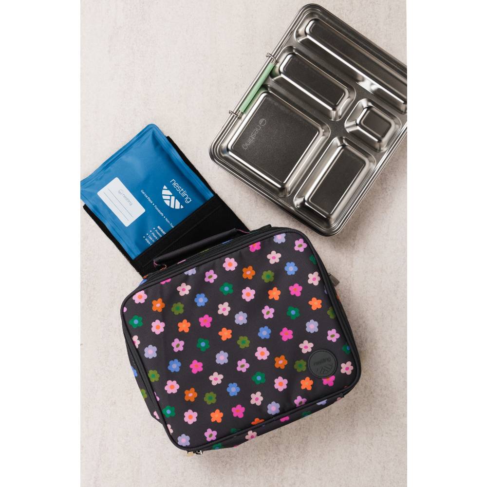 A black lunch bag covered in colorful flower patterns, alongside a blue ice pack and a stainless steel bento box.