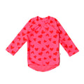 Pink long-sleeve swim rash vest with red heart patterns on a white background