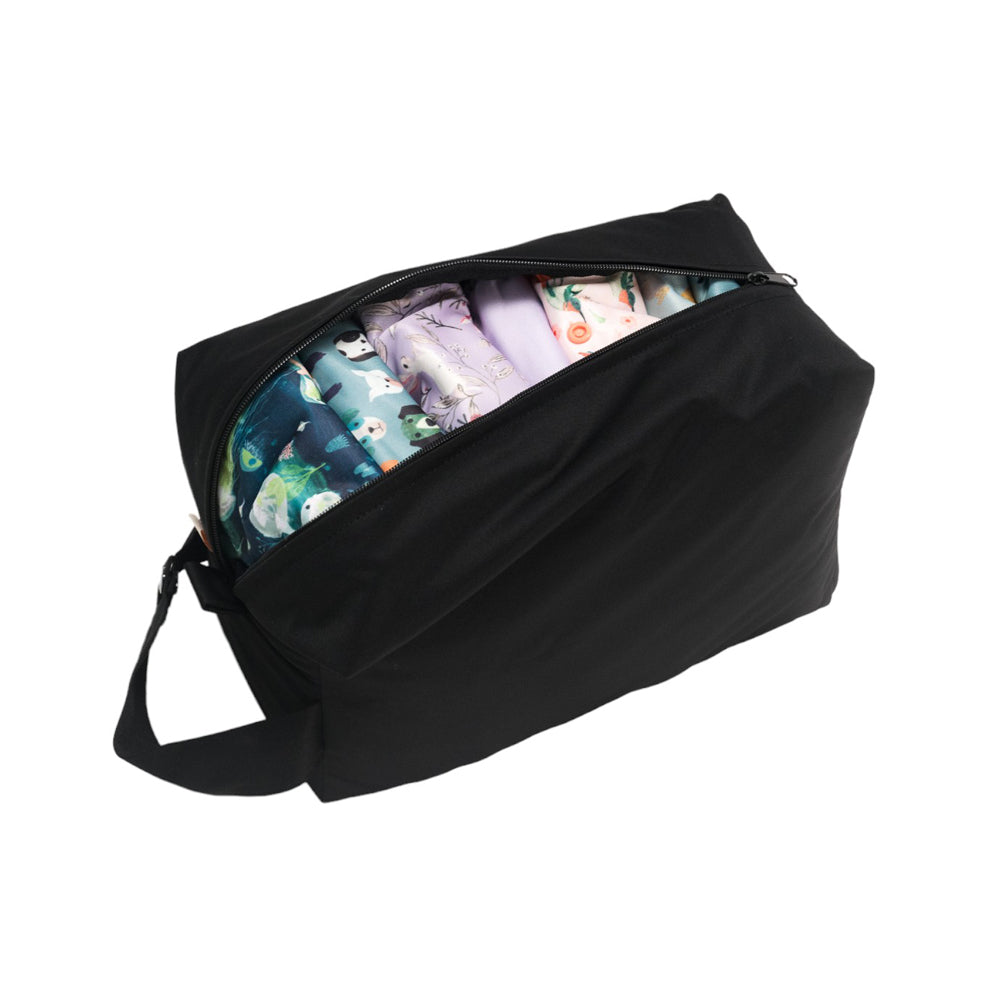 Black nappy storage pod with cloth nappies inside on a white background