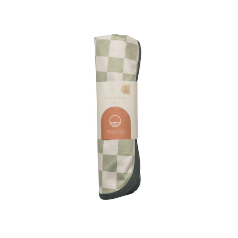 Checkered out & about change mat rolled up with a Nestling brand logo on a white background