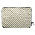 Checkered baby change mat with green and beige pattern on a white background