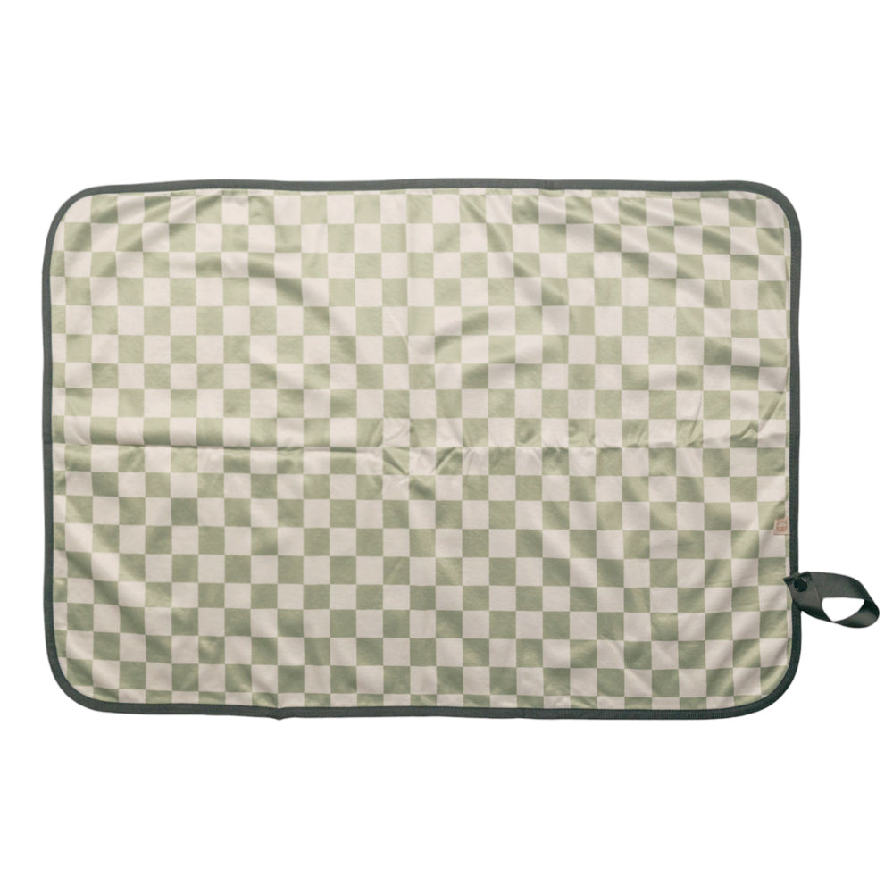 Checkered baby change mat with green and beige pattern on a white background