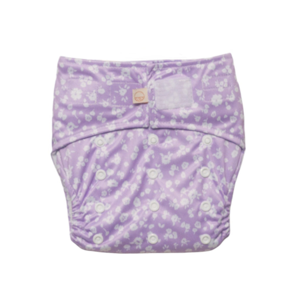 Reusuable nappy with velcro and snaps in purple floral design on a white background