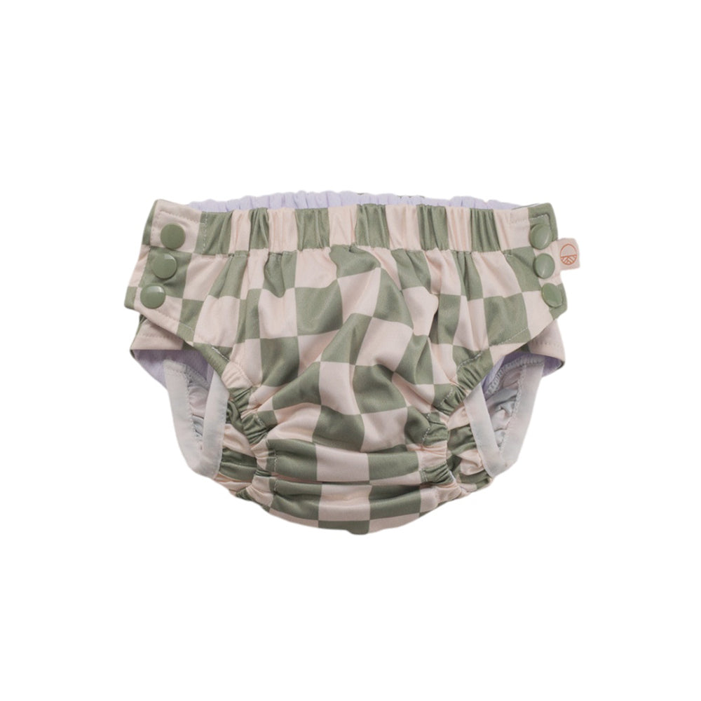 Green and white checkered baby swim nappy on a white background