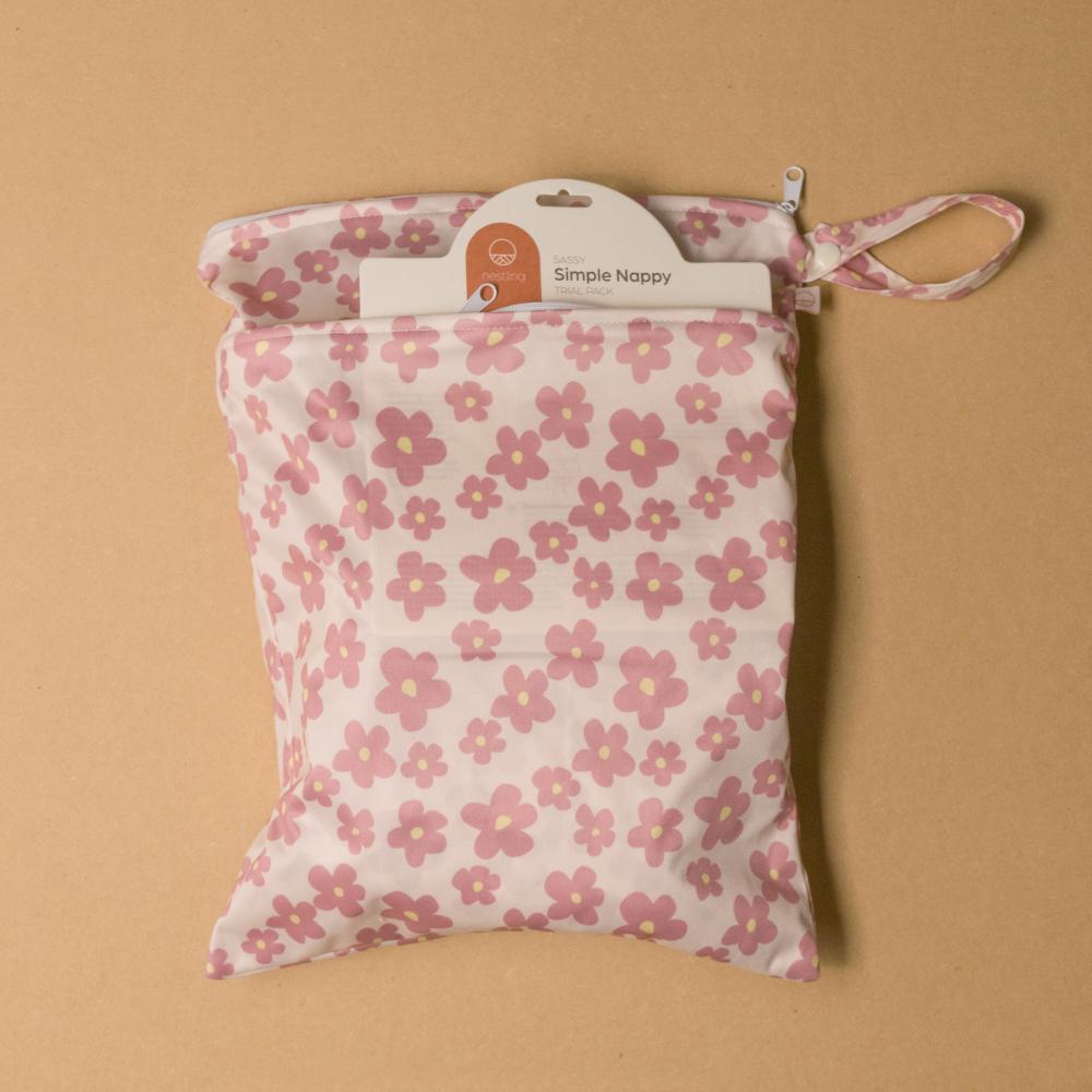 Floral-patterned diaper bag with 'Simple Nappy' label on a beige background