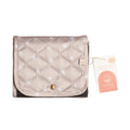 Quilted beige waterproof baby change mat with a gold button and a visible nestling brand tag on a white background