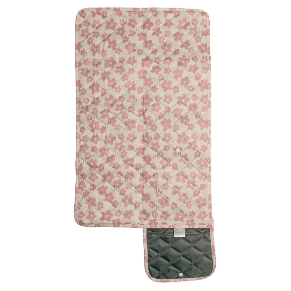 Floral-patterned quilted change mat with a black back on a white background