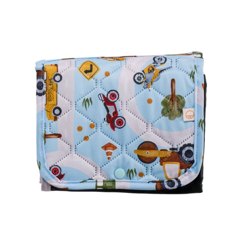 Quilted waterproof change mat with vehicle pattern on a white background