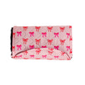 Bow print waterproof kids play mat folded up on white background
