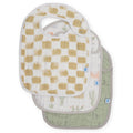 Set of three cotton muslin baby bibs with beige and white checkered, white and green desert prints on a white background