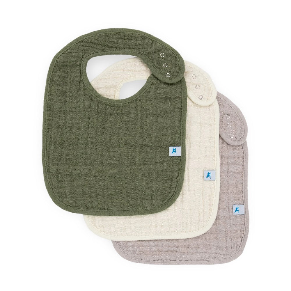 Set of three cotton muslin baby bibs with fern green, cream and grey on a white background