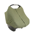 Green cotton muslin baby car seat cover on a white background