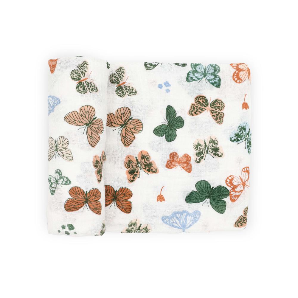 A white cotton muslin swaddle blanket with colourful butterfly patterns on a white background