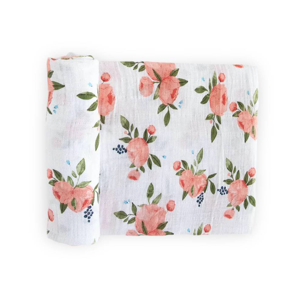 Floral patterned fabric muslin swaddle on a white background