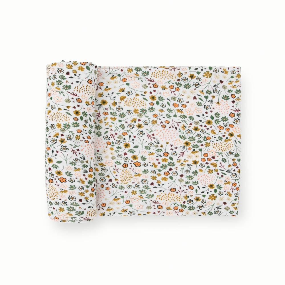 White based floral patterned stretch knit fabric swaddle on a white background