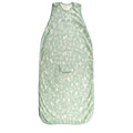 Green woolbabe baby sleeping bag with nature-themed print on a white background