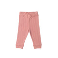 Pink ribbed merino baby pants on a white background