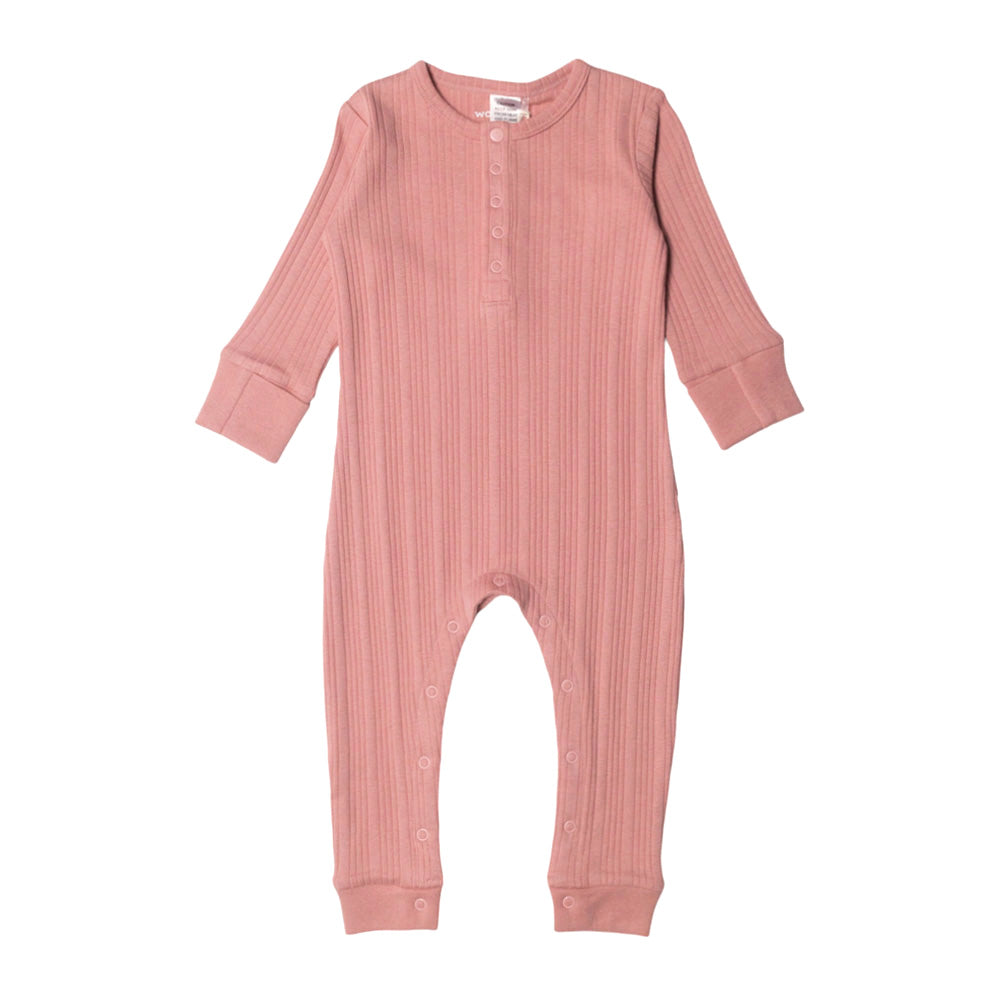 Pink baby woolbabe onesie on a white background