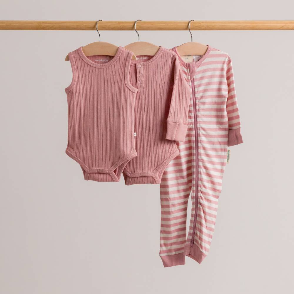 Dusk pink woolbabe collection hanging on a rail