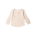 Cream marl merino woolbabe baby top on a light gray background