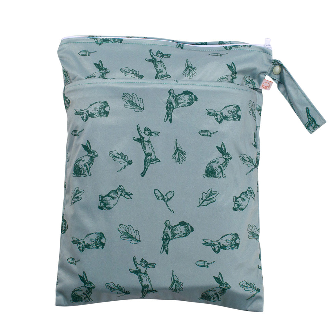 Sage green wet bag with green rabbit pattern on a light blue background