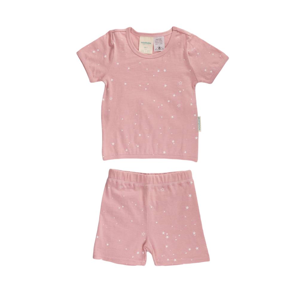 Pink children's woolbabe pajama set with star pattern on a white background