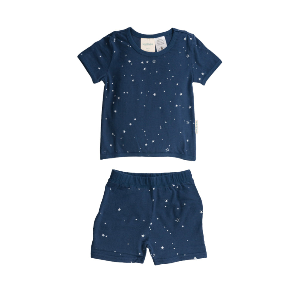 Children's navy blue pyjamas with star patterns on a white background