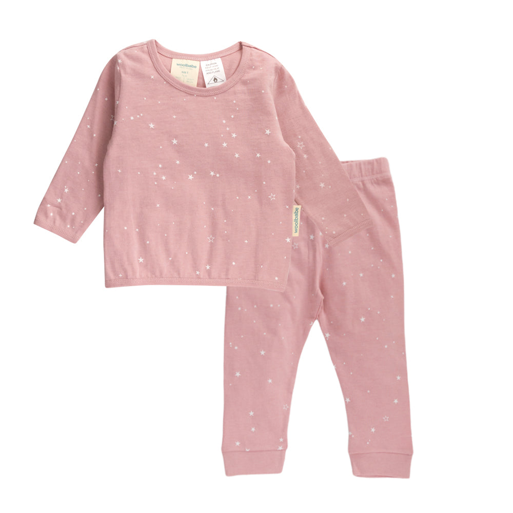 Pink woolbabe children's pajama set with star pattern on a white background