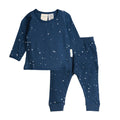 Navy blue woolbabe children's pajama set with star patterns on a white background