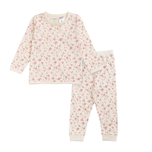 A two-piece children's pajama set featuring a long-sleeve top and matching pants in an off-white fabric with a dense pink and red floral print, laid flat on a white background.