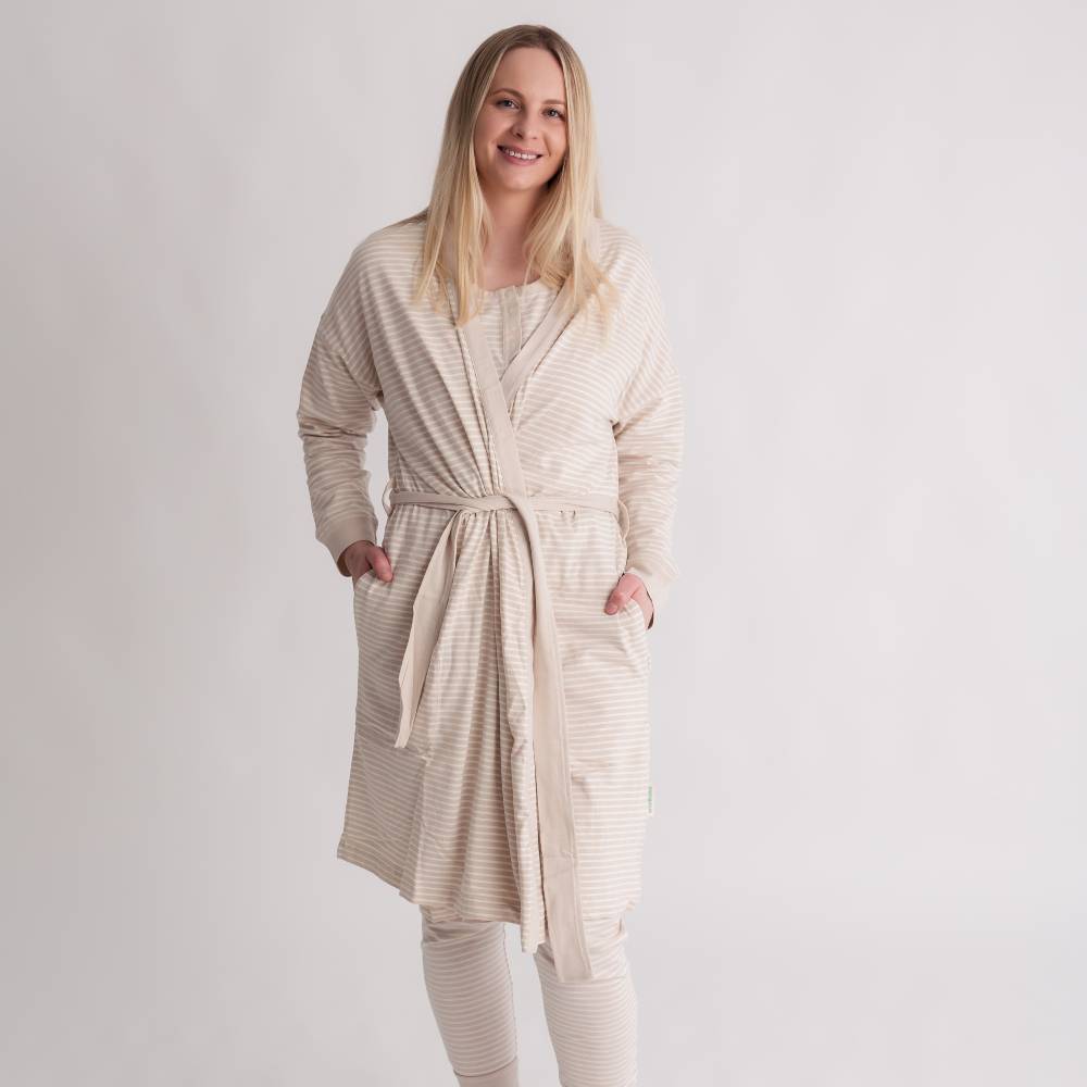 Woman wearing a beige robe and pants set on a white background