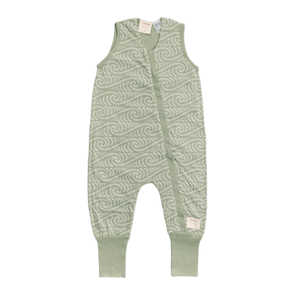 Green baby romper with Maori wave pattern on a white background