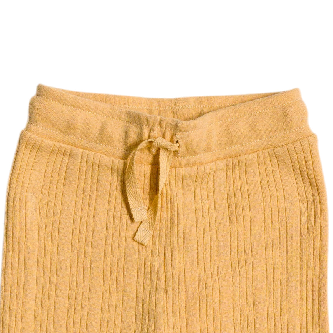 Yellow ribbed woolbabe pants with a drawstring on a white background